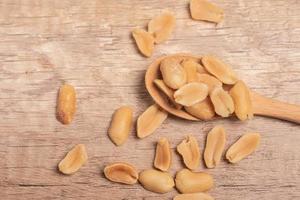 salted roasted peanuts on wooden background photo