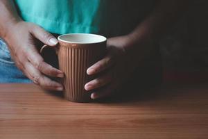 Hand holding a cup of coffee.Copy space photo