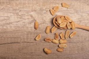 salted roasted peanuts on wooden background photo