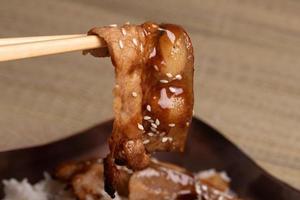 Chopsticks, sliced pork, Japanese sauce photo