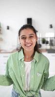 Young woman smiles and claps flour off hands video