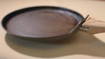 shallow pan for making pancakes close-up video