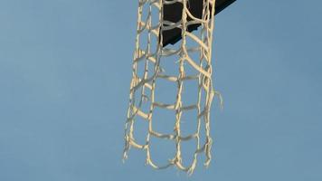 basketball hoop with long mesh, street basketball concept, bottom up panorama video