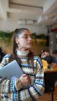 Woman at coffee shop with laptop video