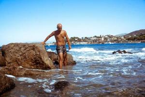 handsome young guy in the blue sea photo