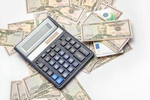 money and the calculator on a table photo