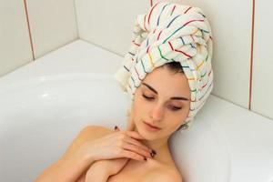 beautiful young girl with a towel on his head photo