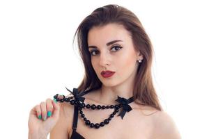 close-up portrait of a chic young Brunettes with a necklace around his neck and red lipstick photo