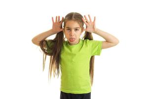 funny little girl in green shirt posing on camera photo