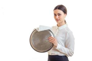 pretty waitress in uniform cleans a trey and posing on camera photo