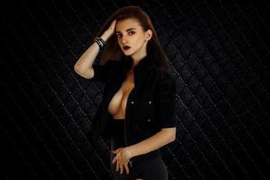 Sexual young brunette girl with big breast in studio photo