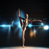 full length photo of ballet dancer posing in theater