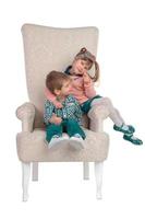 Children sit in a chair photo