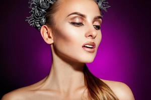 Voluptuous model with beautiful makeup on purple background photo