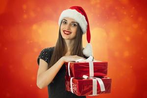 girl in santa hat with red gift box photo