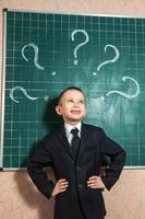 Boy near the green blackboard photo