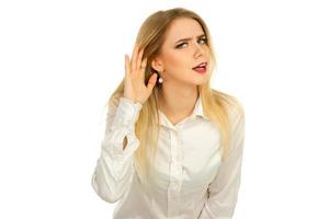 young blonde listens and put a hand to her ear photo