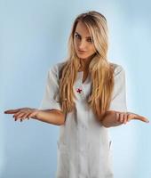 beautiful nurse offering two pills photo