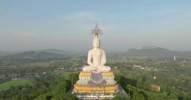 An aerial view of Big Buddha on the mountain stands prominently at Nong Hoi Temple in Ratchaburi near the Bangkok, Thailand