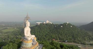 An aerial view of Big Buddha on the mountain stands prominently at Nong Hoi Temple in Ratchaburi near the Bangkok, Thailand