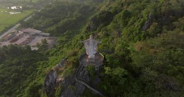 An aerial view of Christ the Redeemer on the mountain stands prominently at Hup Pha Sawan in Ratchaburi near the Bangkok, Thailand