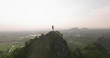 An aerial view of Buddha on the mountain stands prominently at Hup Pha Sawan in Ratchaburi near the Bangkok, Thailand