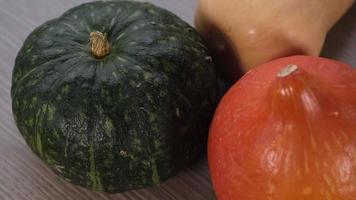 Colorful pumpkins rotating. Group of fresh healthy vegetables. Green, orange and yellow pumpkin food. video