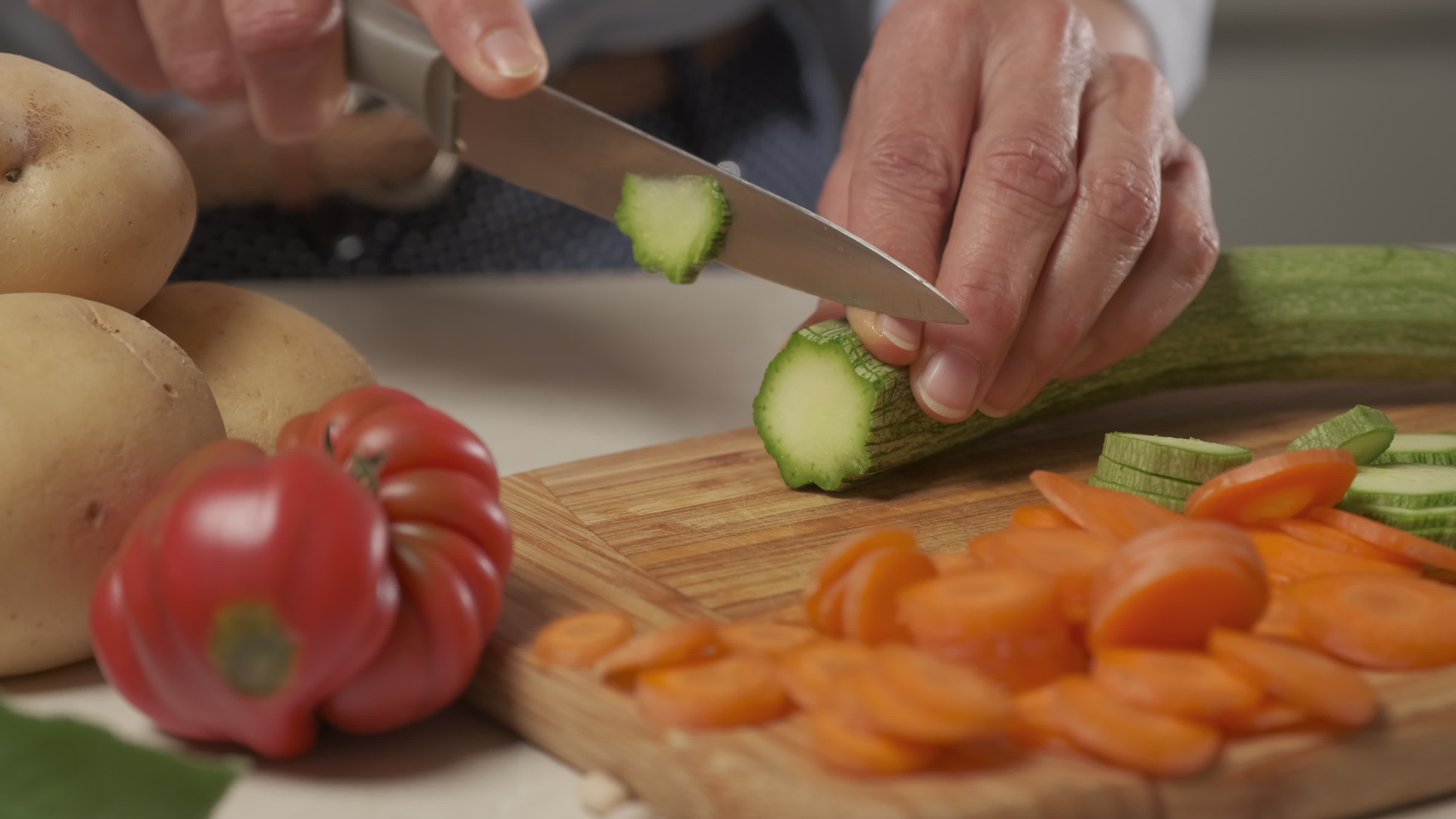 Woman cutting slicing vegetables zucchini, Mediterranean diet food