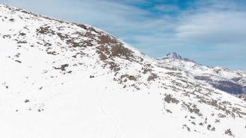 dos amigos se relajan, descansan, se sientan y disfrutan del panorama montañoso después de la caminata antes de descender libremente en el área de kobi de la estación de esquí de gudauri en la estación de esquí de georgia, cáucaso