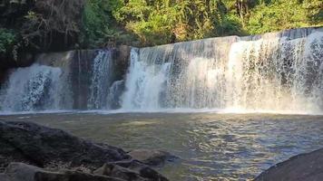 Front view, Sri Dit Waterfall is a small and forested one-level waterfall with sunlight at Khao Kho, Phetchabun Province, Thailand. video