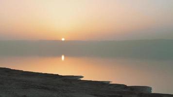 Scenic panoramic view of dead sea shoreline in misty evening on sunset from viewpoint in Jordan video