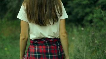 stylish cute girl walks through the green forest video