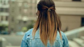 young charming girl with red lips posing in the street in the city video