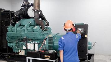 Pefessional engineering check and test perfomance the generator engine operarion. photo