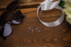 wedding rings in hand. Two wedding rings on the floor with contrast wedding rings on floor, on ground, on piano, in hand on grass or a stones, photo