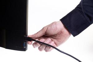 IT engineer Man hand inserts cable into monitor. Man hand connecting the DVI cable for monitor to computer PC. VGA DVI DisplayPort and power cable. close up in the hands of an . isolated photo