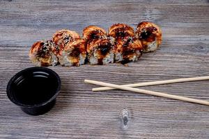 Traditional delicious fresh sushi roll set on a black background with reflection. Sushi roll with rice, cream cheese, avocado, salmon, sesame. Philadelphia. Sushi menu. Japanese kitchen, photo