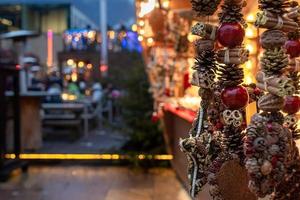 Christmas ornaments and in blurred background gastronomic stand at traditional famous market
