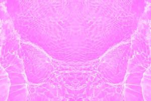 Defocus blurred transparent purple colored clear calm water surface texture with splashes and bubbles. Trendy abstract nature background. Water waves in sunlight with copy space. Pink water drop shine photo