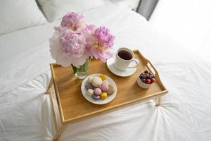 Tray with breakfast on bed. photo