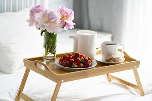 Tray with breakfast on bed. photo