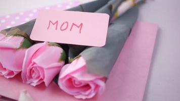 Mothers day concept with pink color rose flower and mom text on paper video