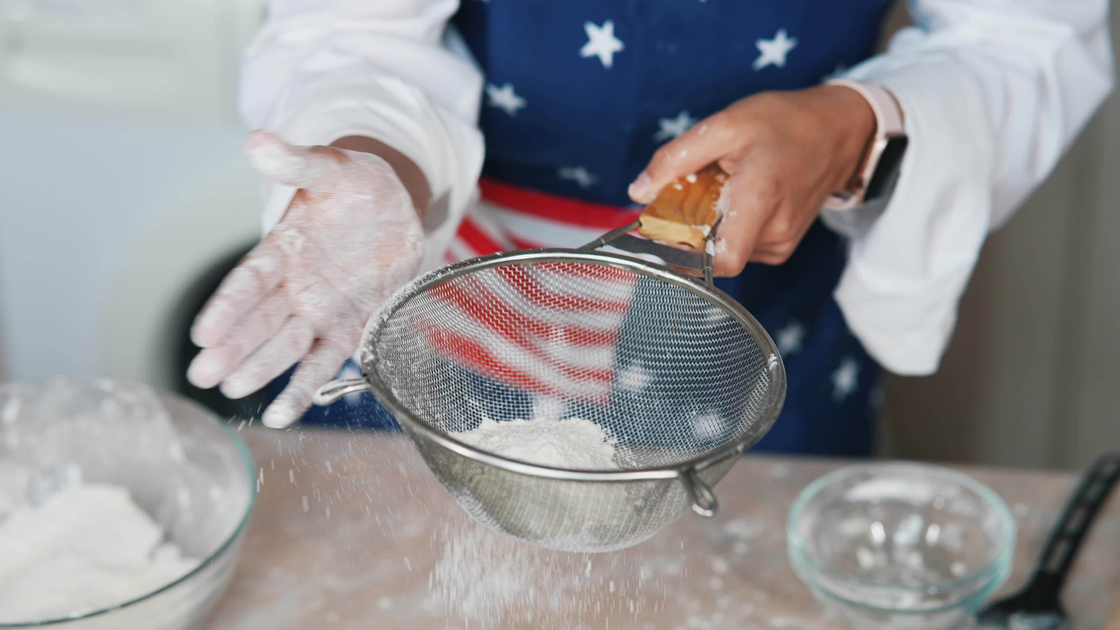 Sifting flour for baking 16089325 Stock Video at Vecteezy