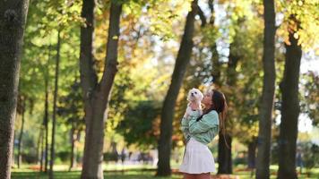 Woman in park holds white dog video