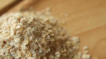 Close up of oats flakes and honey in a container on table video