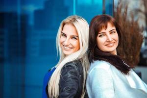 portrait of two glamour ladies blonde and brunette looking at the camera photo