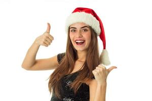 portrait of cheerful pretty girl in santa hat photo