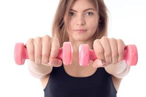 close-up of young athletic girl with dumbbells photo