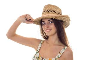 pretty lady in straw hat and sarafan with floral pattern looking at the camera and smiling isolated on white background photo