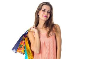 young girl stands up straight and keeps the shoulder bags isolated on white background photo